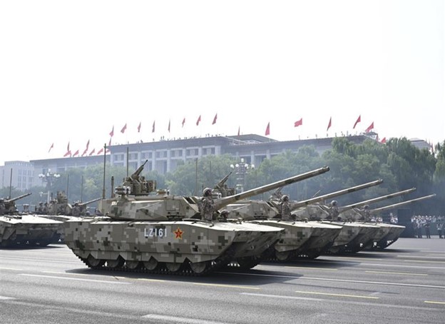 Figure 1. The Type-100 tank followed by the Type-100 support vehicle make their debut at the September 3, 2025, military parade in Beijing
